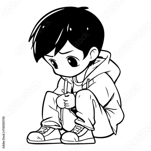 Sad boy sitting and holding a pencil in his hand.