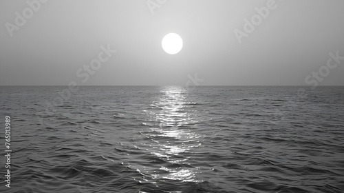 black and white water surface with ripples and sunlight reflections