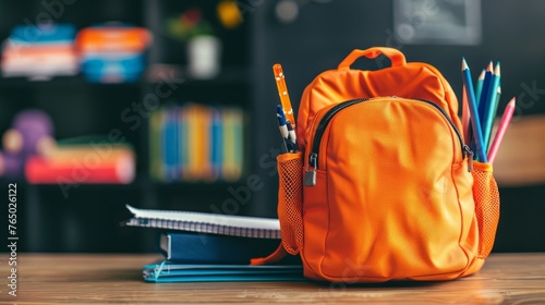 Happy child with orange schoolbag playing on colorful playground background, back to school supplies, multicolor backpack with pencils and books for studying, education concept for children photo