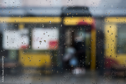 closeup of the rain drops of the window at the tramway station in the street © pixarno