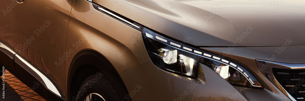 Golden SUV by sunset. Close up of the headlights. - obrazy, fototapety, plakaty 