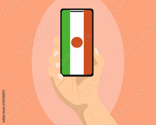 Niger flag on mobile phone screen, holding smartphone, advertising social media or banner concept