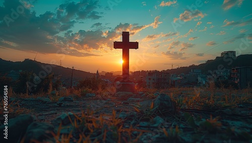 An old rugged wooden cross stands on a hill at sunset with a beautiful sky full of clouds in the background. The cross is a symbol of Christianity and the resurrection of Jesus Christ. photo