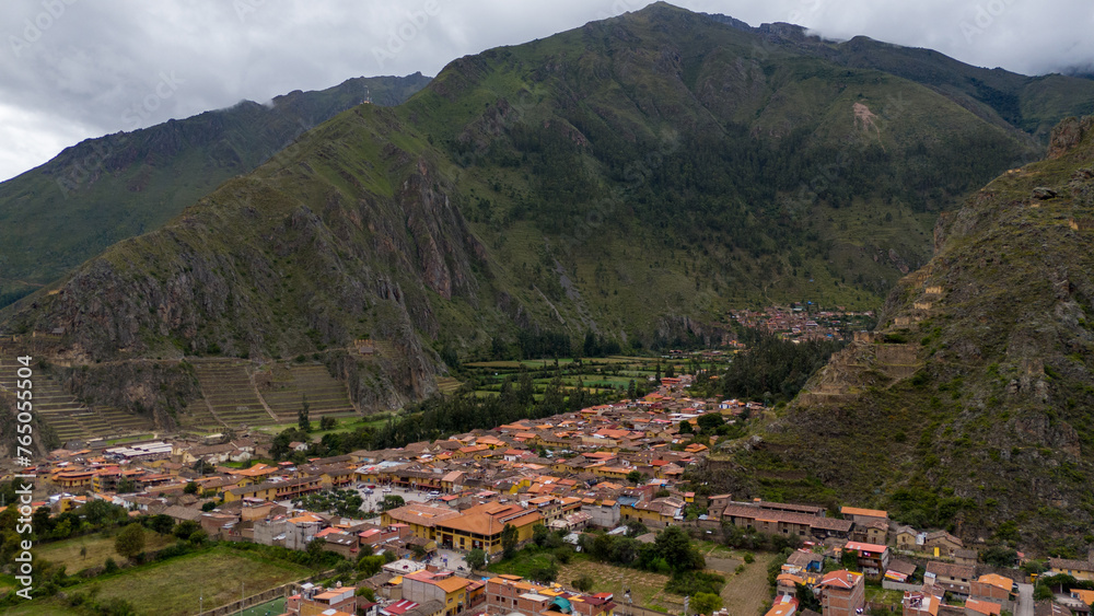 Aerial Drone view of Ollantaytambo Inca city town in Peru mountains and Inca ruins