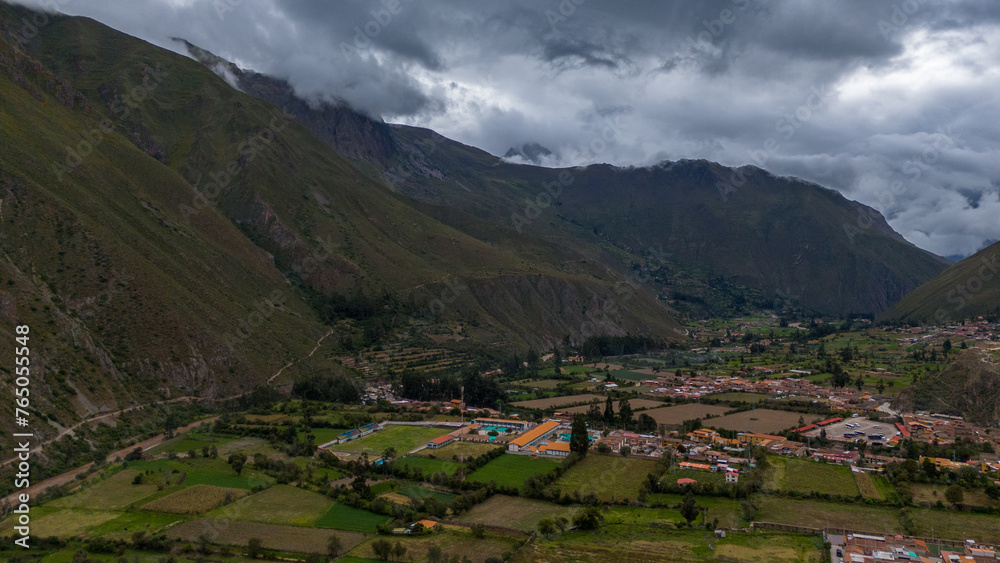 Aerial Drone view of Ollantaytambo Inca city town in Peru mountains and Inca ruins