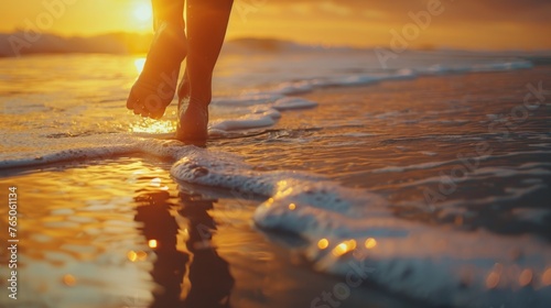 Close-up of bare feet in soft sand on a tranquil beach during sunset 