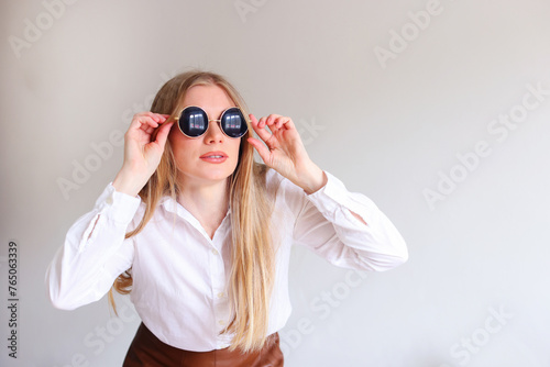 girl in black sunglasses on a white background  copy space for text