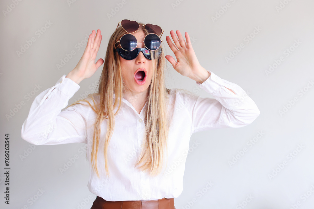 girl chooses sunglasses on a white background girl chooses sunglasses on a white background