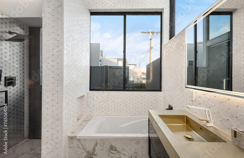Modern bathroom with contemporary sinks, mirrors, and window