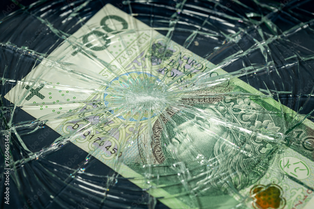 Poland money, Fall of the Polish currency, Weakening of the Polish zloty 100 zloty banknote lying behind the broken window, Financial concept or insurance costs