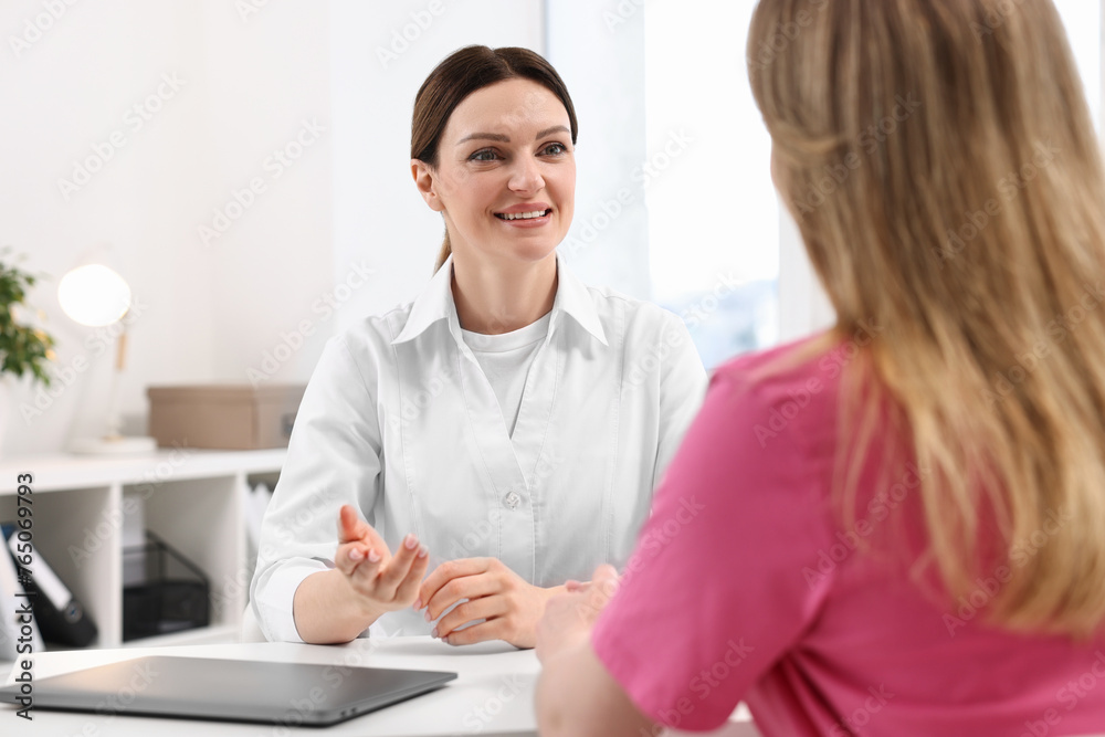 Mammologist consulting woman during appointment in hospital Mammologist consulting woman during appointment in hospital