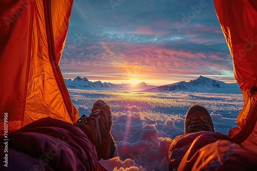 An explorers view from inside a tent looking out at a breathtaking polar landscape at sunrise. The silhouette of distant mountains against the brightening sky