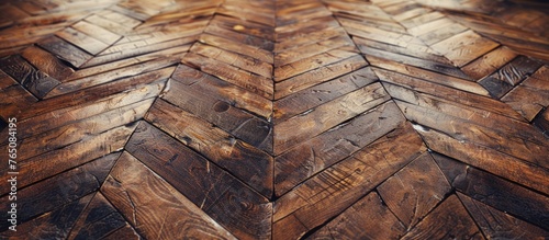 A close-up view of a wooden floor featuring a unique herringbone pattern, adding a stylish and classic touch to the room