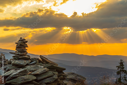 Fototapeta Naklejka Na Ścianę i Meble -  Stone cairns at sunset (Skalny Stół) in summer with a view of Śnieżka and the entire Karkonosze