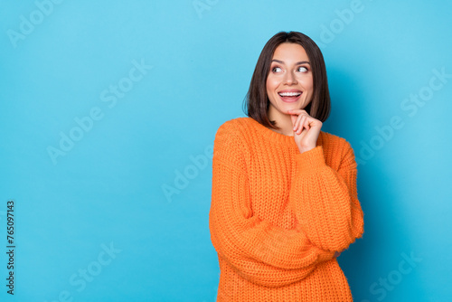 Portrait of attractive funny cheerful girl making decision copy empty blank space isolated over bright blue color background