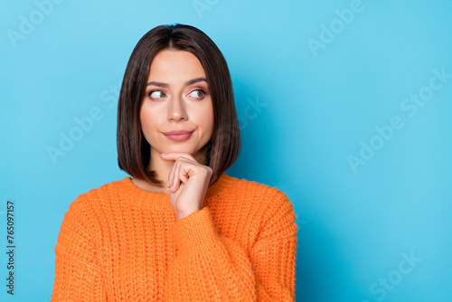 Portrait of attractive cheery girl making decision copy blank space place solution isolated over bright blue color background