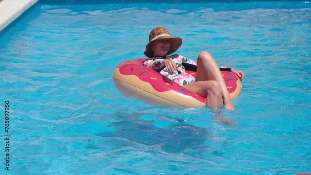 Woman on inflatable lap with beach ball in swimming pool sunny day. Funny summer vacation Woman on inflatable lap with beach ball in swimming pool sunny day. Funny summer vacation