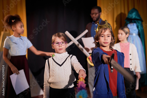 Waist up portrait of boy and girl standing on stage in theater and rehearsing school play copy space photo