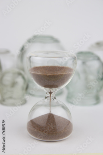 Hourglass on on background of glass hijama jars. Bloodletting. Sunnah treatment. Islam.