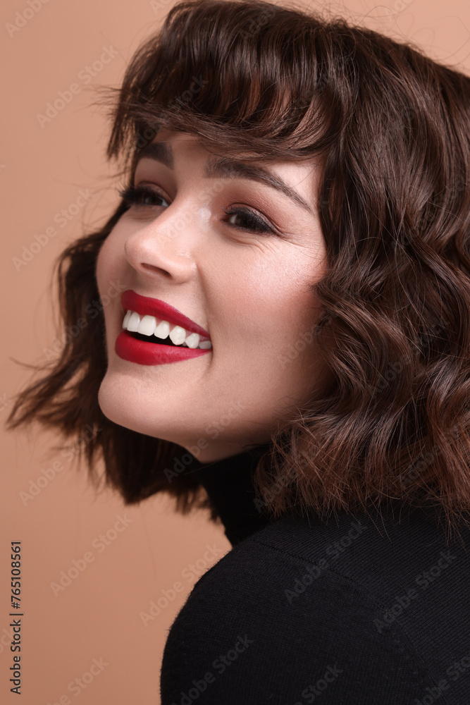Beautiful young woman with wavy hairstyle on beige background Beautiful young woman with wavy hairstyle on beige background