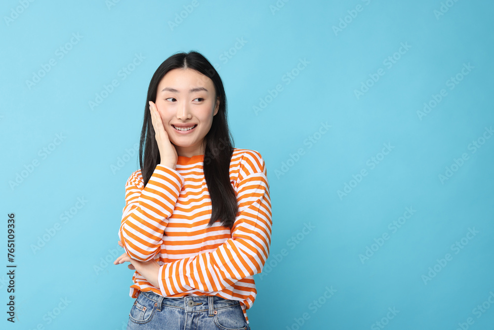 Portrait of happy woman on light blue background. Space for text Portrait of happy woman on light blue background. Space for text