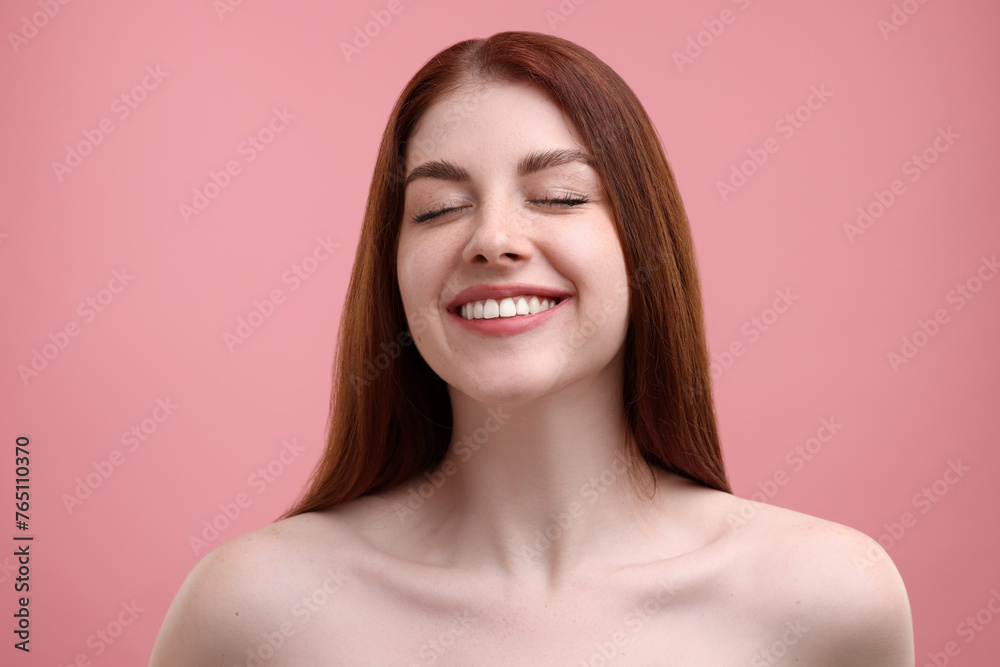 Portrait of smiling woman with freckles on pink background Portrait of smiling woman with freckles on pink background