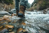 close-up view of a hiker crossing a river wearing hiking boots
