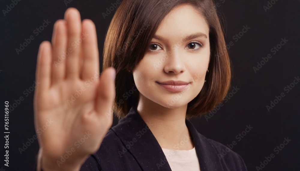 Close up of woman showing stop gesture with hand raising up on black background, young female protesting against domestic violence and abuse, bullying, saying no to gender discrimination Close up of woman showing stop gesture with hand raising up on black background, young female protesting against domestic violence and abuse, bullying, saying no to gender discrimination