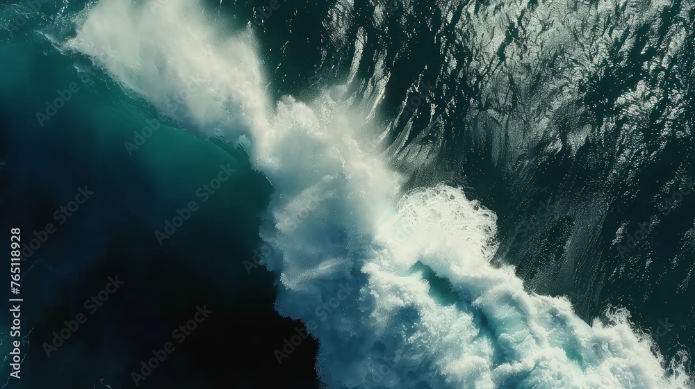 View of the ocean, highlighting a large wave with white foam against the deep blue water