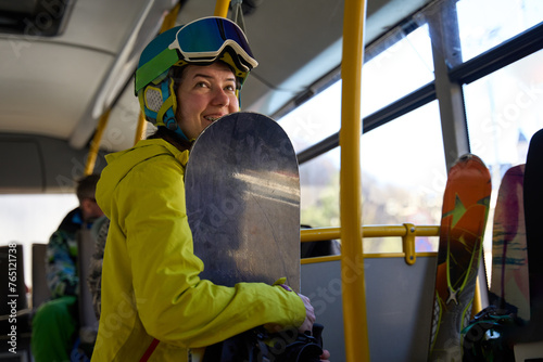 Snowboarder go on a bus, ready for a day on the slopes.