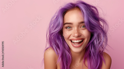 Smiling woman with purple hair and freckles.