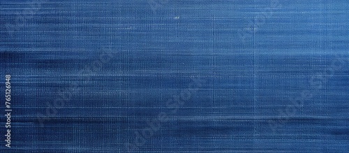 A detailed view of a piece of fabric in blue color with a single white stripe running across