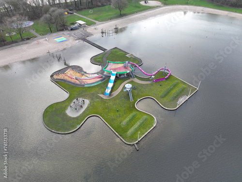 Aerial drone view on a childrens playground in the form of a large puzzle piece. Slide and colorfull climbing and playing installations. The Netherlands.