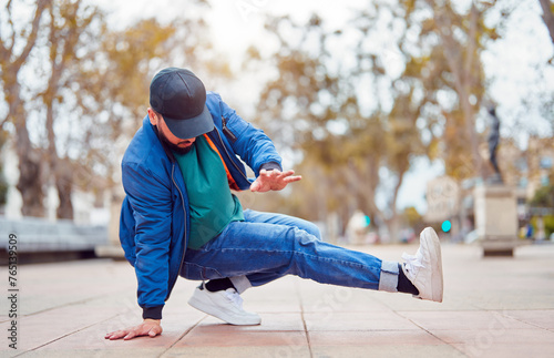Картината върху платно breakdancer guy performing downrock or floor based footwork stunt on the street