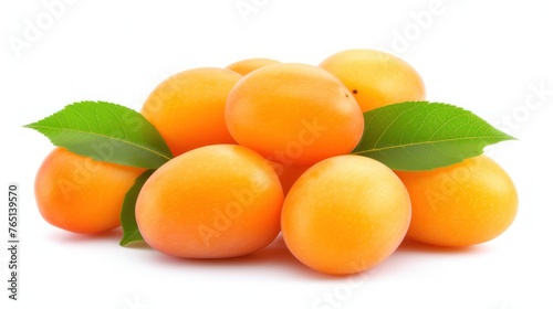 a pile of ripe apricots with a green leaf on the top of one of the apricots.