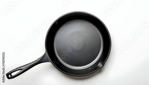 Empty cast iron frying pan over white background, view from above. Food background