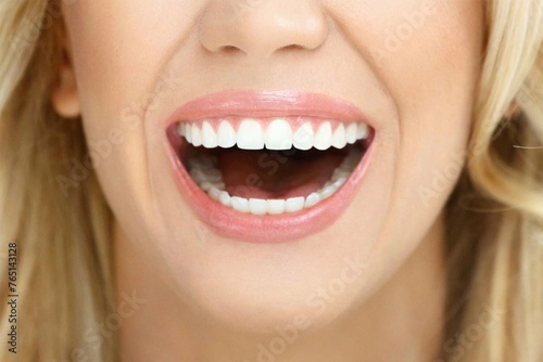 Close-up Close-up of the face of a beautiful young woman smiling with pink lips and soft blonde hair - Young woman laughing
