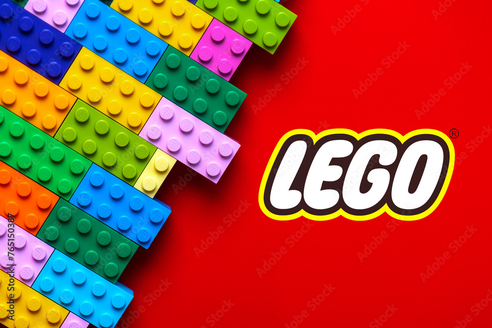 Naklejka premium Close up of colorful Lego blocks with the Lego logo. Illustrative editorial