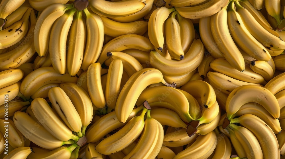 a large pile of ripe bananas sitting on top of a pile of unripe bananas on top of each other.