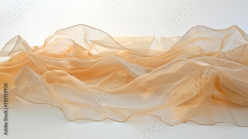 a close up of a piece of cloth on a white surface with a blurry image of mountains in the background.