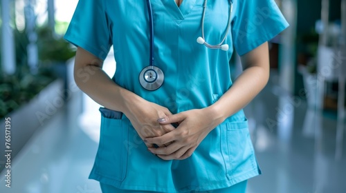 Female doctor in white lab coat with stethoscope in hospital hallway. Professional medical staff with place for text.