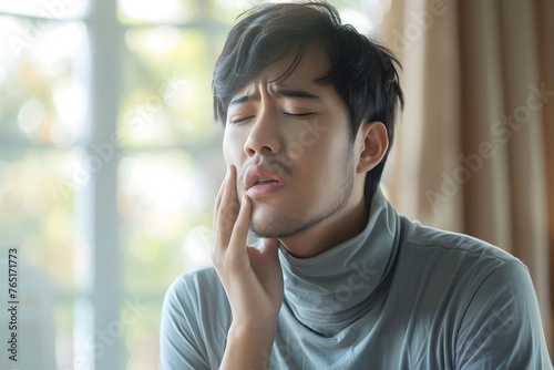 young man have toothache at home