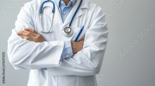 A medical professional in a white lab coat stands with arms crossed, wearing a stethoscope.
