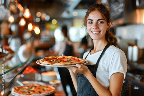 A friendly waitress in a restaurant holding a plate of pizza, ready to serve customers in the background, showcasing hospitality and food service