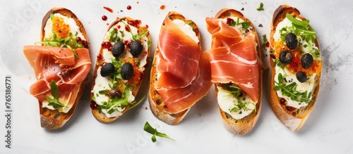 Four bread slices with assorted toppings on table