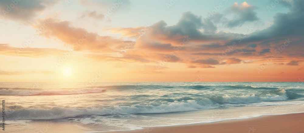 Sunset over the ocean with waves crashing on the beach
