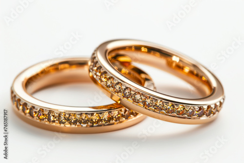 Exquisite Gold Wedding Bands Adorned with Gemstones on a Pure White Background, Radiating Elegance and Sophistication