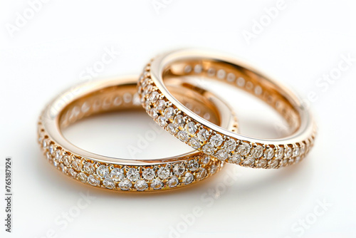 Exquisite Gold Wedding Bands Adorned with Gemstones on a Pure White Background