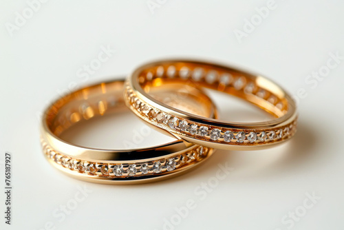 Exquisite Gold Wedding Bands Adorned with Gemstones on a Pure White Background, Capturing Timeless Elegance