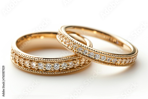 Exquisite Gold Wedding Bands Adorned with Precious Stones on a White Background, Radiating Elegance